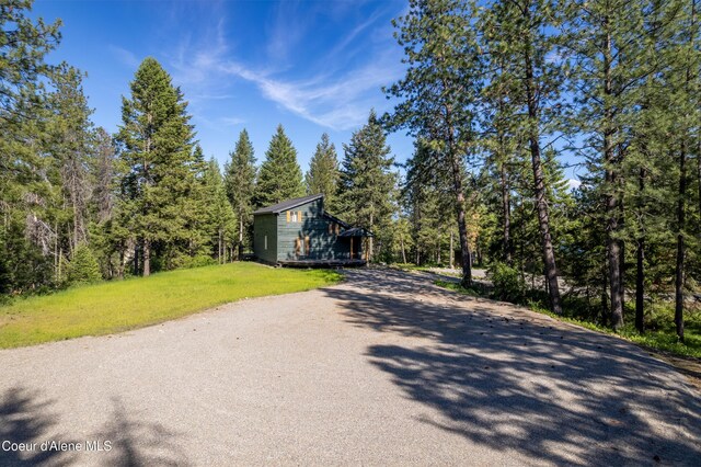 28729 Ramsey Rd, Athol, ID 83801 - view of asphalt driveway featuring a view of trees