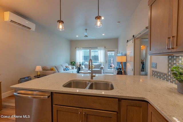3304 N Rosalia Rd, Coeur Dalene, ID 83814 - kitchen with dishwasher, a wall unit AC, a barn door, open floor plan, and ceiling fan