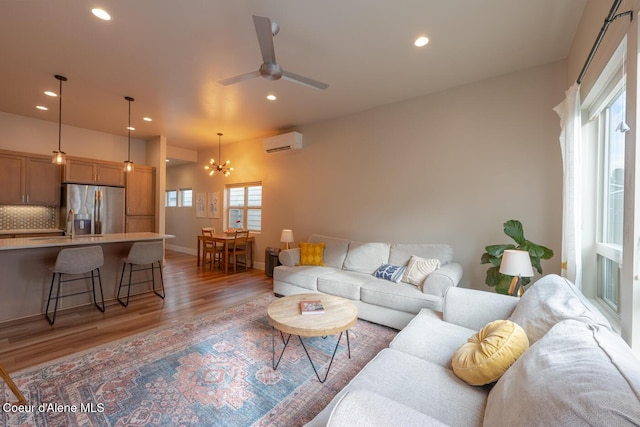 3304 N Rosalia Rd, Coeur Dalene, ID 83814 - living room featuring an AC wall unit, light wood-style floors, recessed lighting, a chandelier, and ceiling fan