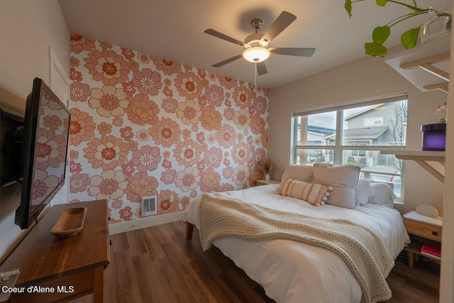 3304 N Rosalia Rd, Coeur Dalene, ID 83814 - bedroom featuring wallpapered walls, wood finished floors, a ceiling fan, and an accent wall