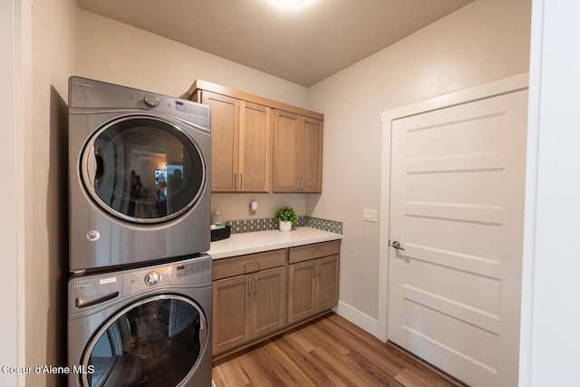 3304 N Rosalia Rd, Coeur Dalene, ID 83814 - washroom with stacked washer / drying machine, cabinet space, and light wood finished floors
