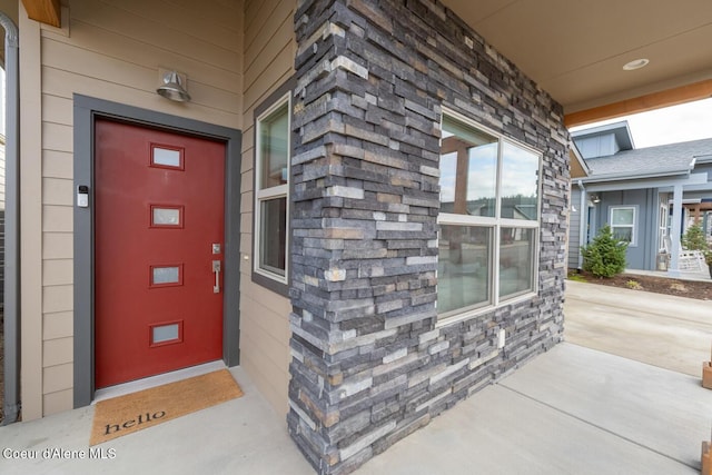 3304 N Rosalia Rd, Coeur Dalene, ID 83814 - property entrance with stone siding and a porch