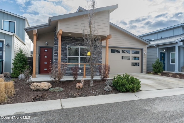 3304 N Rosalia Rd, Coeur Dalene, ID 83814 - view of front of home with driveway, an attached garage, and covered porch