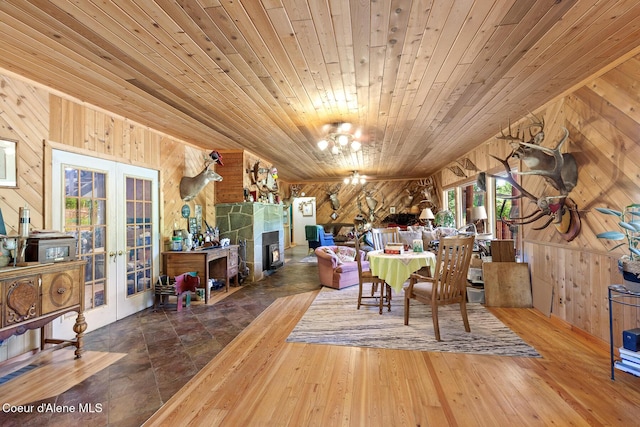 784 Twin Rivers Rd, Athol, ID 83801 - dining area with wooden walls, wood ceiling, french doors, healthy amount of natural light, and a chandelier