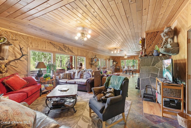 784 Twin Rivers Rd, Athol, ID 83801 - living area with wood ceiling, wood walls, stone finish floors, and a chandelier