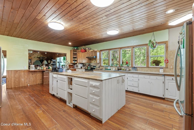 784 Twin Rivers Rd, Athol, ID 83801 - kitchen with stainless steel appliances, open shelves, a center island, wainscoting, and light countertops