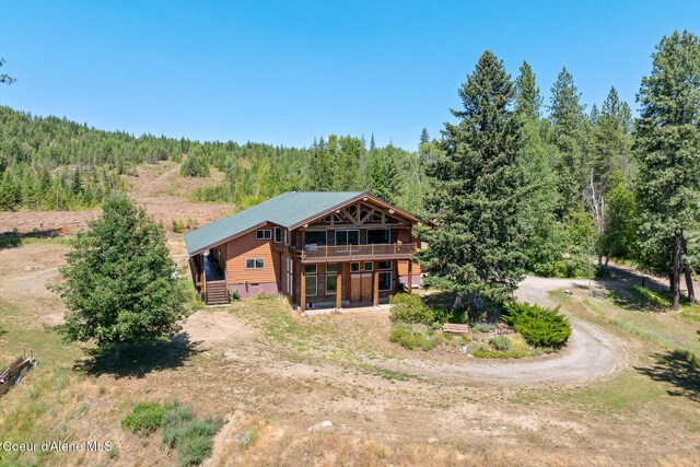 784 Twin Rivers Rd, Athol, ID 83801 - rear view of property featuring a forest view, dirt driveway, and a deck