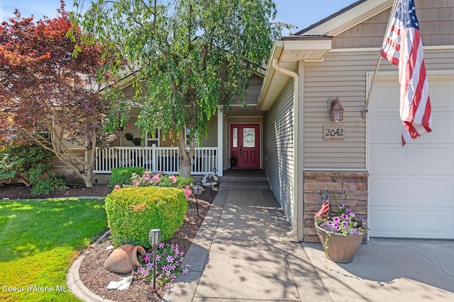 2042 W Heavenly Star Ct, Post Falls, ID 83854 - view of exterior entry featuring an attached garage and a porch