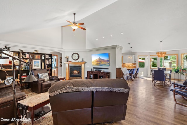 2042 W Heavenly Star Ct, Post Falls, ID 83854 - living area featuring a ceiling fan, wood finished floors, a fireplace, high vaulted ceiling, and a chandelier