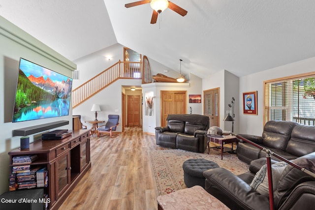 2042 W Heavenly Star Ct, Post Falls, ID 83854 - living area with a ceiling fan, light wood-style flooring, stairs, and high vaulted ceiling
