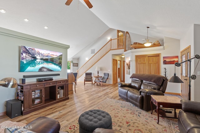 2042 W Heavenly Star Ct, Post Falls, ID 83854 - living area with stairway, a ceiling fan, light wood finished floors, recessed lighting, and high vaulted ceiling