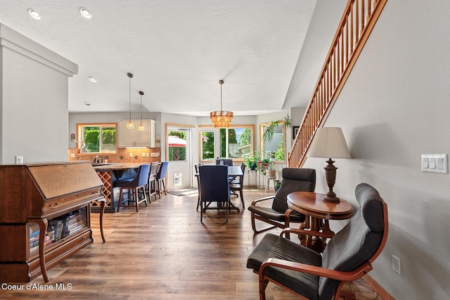 2042 W Heavenly Star Ct, Post Falls, ID 83854 - living room featuring wood finished floors, stairway, a textured ceiling, and a chandelier