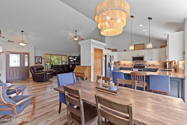 2042 W Heavenly Star Ct, Post Falls, ID 83854 - dining area with ceiling fan, light wood finished floors, and high vaulted ceiling