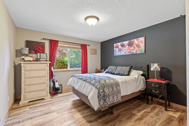 2042 W Heavenly Star Ct, Post Falls, ID 83854 - bedroom featuring wood finished floors and a textured ceiling