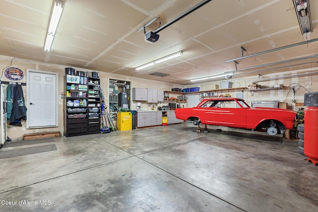 2042 W Heavenly Star Ct, Post Falls, ID 83854 - garage with a garage door opener and gas water heater