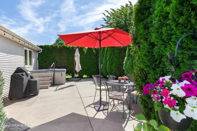 2042 W Heavenly Star Ct, Post Falls, ID 83854 - view of patio with a hot tub, outdoor dining area, and area for grilling