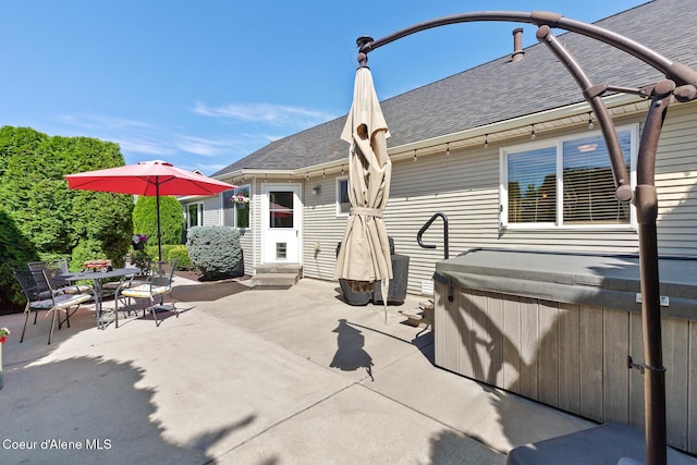 2042 W Heavenly Star Ct, Post Falls, ID 83854 - rear view of house featuring roof with shingles, a patio area, outdoor dining area, entry steps, and a hot tub