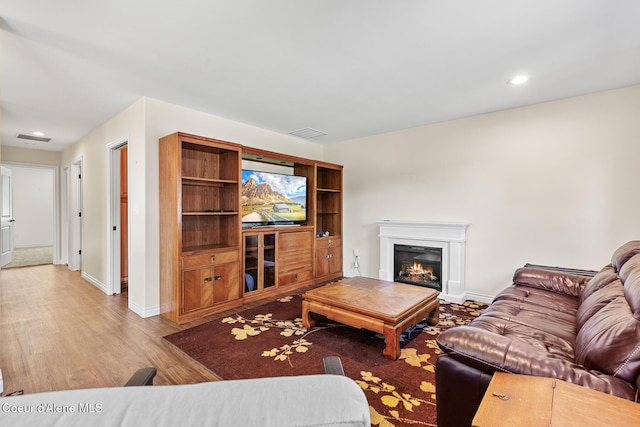 2042 W Heavenly Star Ct, Post Falls, ID 83854 - living room with wood finished floors, recessed lighting, and a glass covered fireplace