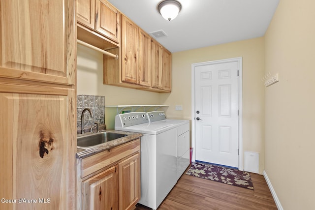 2042 W Heavenly Star Ct, Post Falls, ID 83854 - laundry area with washing machine and clothes dryer, wood finished floors, and cabinet space