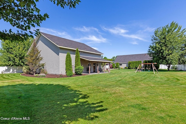 2042 W Heavenly Star Ct, Post Falls, ID 83854 - rear view of house featuring a playground, a patio area, and a fenced backyard