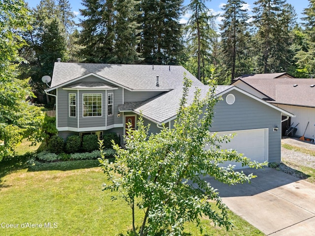 7386 W Sunrise Ct, Rathdrum, ID 83858 - view of front facade with roof with shingles, an attached garage, a front yard, and concrete driveway