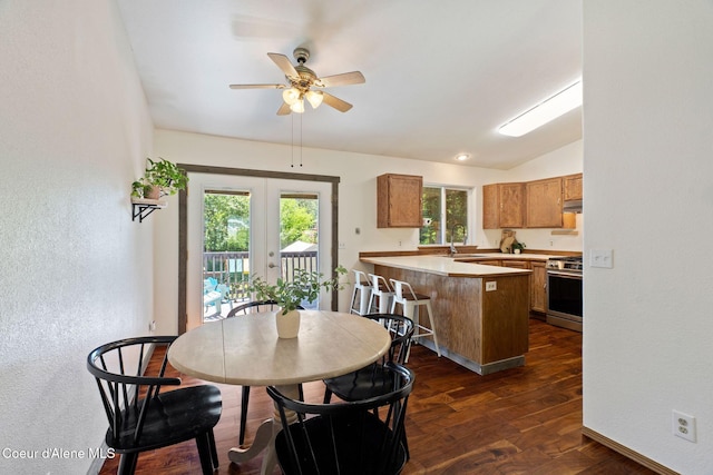 7386 W Sunrise Ct, Rathdrum, ID 83858 - dining area featuring ceiling fan, a textured wall, vaulted ceiling, dark wood-style flooring, and french doors
