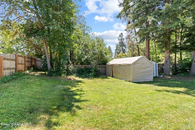 7386 W Sunrise Ct, Rathdrum, ID 83858 - fenced backyard with an outbuilding and an exterior structure