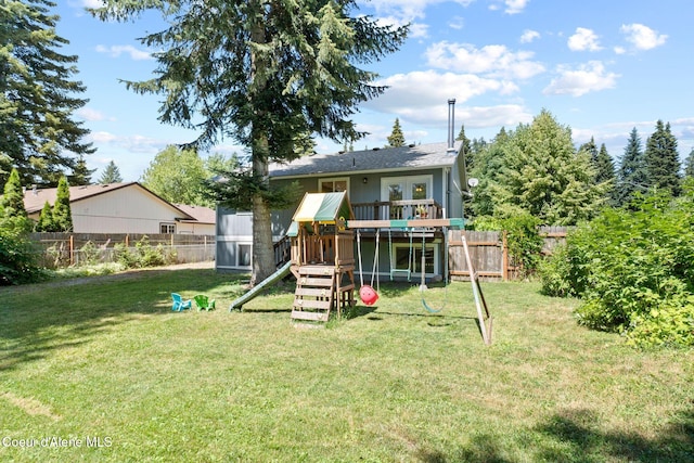 7386 W Sunrise Ct, Rathdrum, ID 83858 - back of house featuring a playground and a fenced backyard