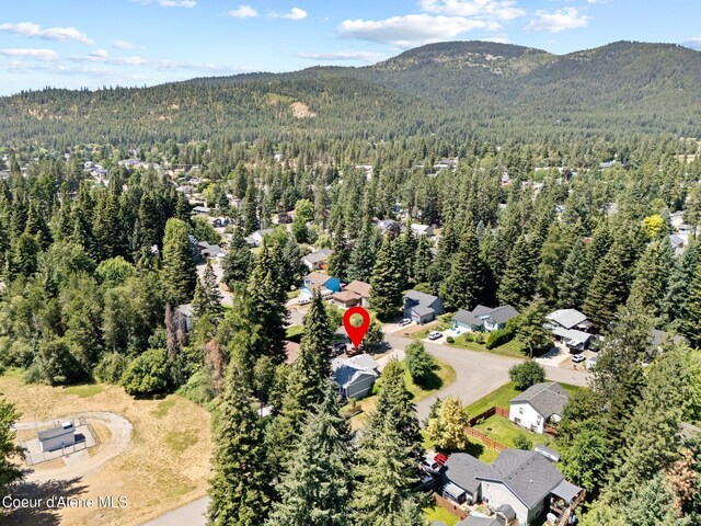7386 W Sunrise Ct, Rathdrum, ID 83858 - aerial view of property and surrounding area with a heavily wooded area and a mountain backdrop