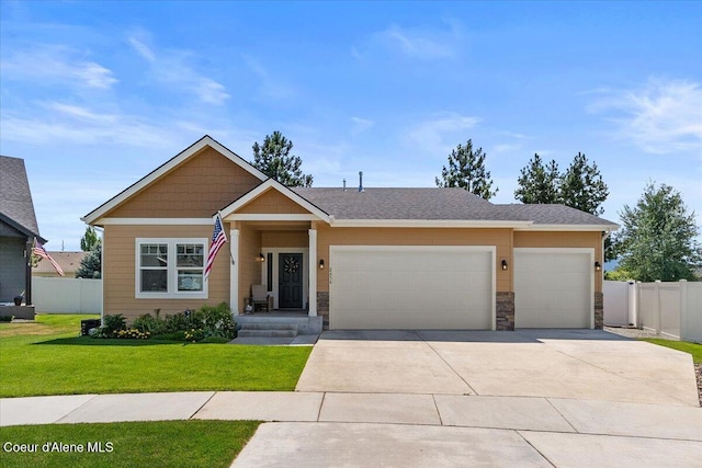 2636 N Wrenley Ln, Post Falls, ID 83854 - view of front of home featuring driveway, a garage, and stone siding