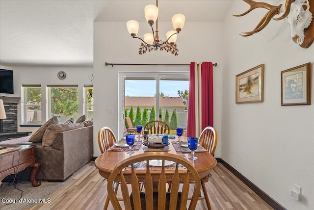 2636 N Wrenley Ln, Post Falls, ID 83854 - dining room with light wood finished floors and a chandelier