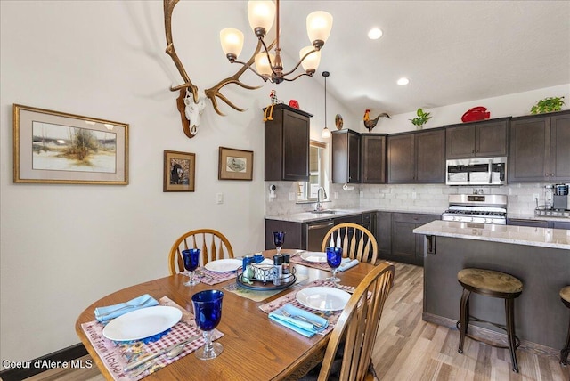2636 N Wrenley Ln, Post Falls, ID 83854 - dining area with a chandelier, light wood-style floors, and vaulted ceiling