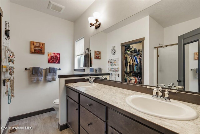 2636 N Wrenley Ln, Post Falls, ID 83854 - full bath featuring double vanity, a walk in closet, and a shower