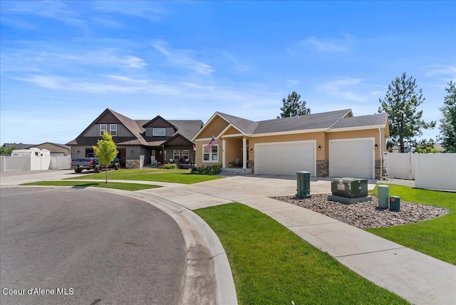 2636 N Wrenley Ln, Post Falls, ID 83854 - view of front of home featuring stone siding, a garage, and concrete driveway