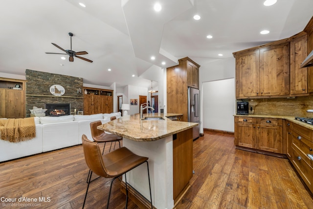 12500 N Partridge Way, Hayden, ID 83835 - kitchen featuring high quality fridge, a kitchen bar, light stone counters, ceiling fan, and recessed lighting