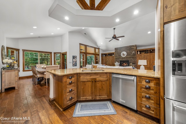 12500 N Partridge Way, Hayden, ID 83835 - kitchen featuring appliances with stainless steel finishes, open floor plan, dark wood finished floors, light stone countertops, and recessed lighting