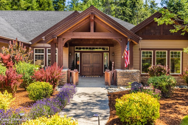 12500 N Partridge Way, Hayden, ID 83835 - doorway to property featuring roof with shingles and stone siding