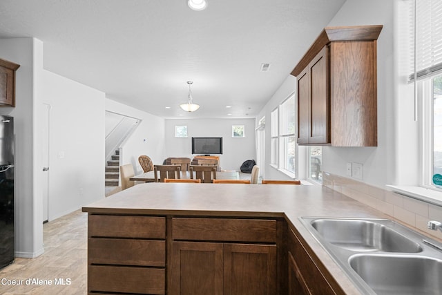 21714 S Lakeview Dr, Worley, ID 83876 - kitchen with a peninsula, light countertops, recessed lighting, decorative light fixtures, and freestanding refrigerator