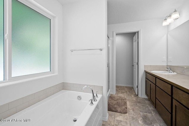 21714 S Lakeview Dr, Worley, ID 83876 - full bathroom with vanity, a bath, and stone finish floors