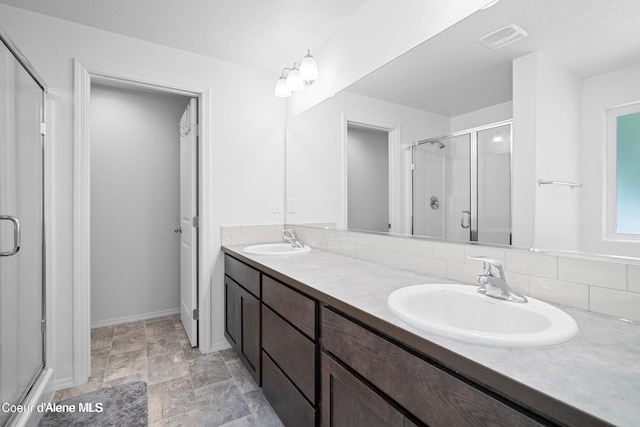21714 S Lakeview Dr, Worley, ID 83876 - bathroom with a stall shower, double vanity, decorative backsplash, and stone finish floors