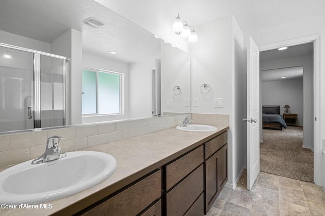 21714 S Lakeview Dr, Worley, ID 83876 - ensuite bathroom with decorative backsplash, double vanity, a shower stall, stone finish flooring, and recessed lighting