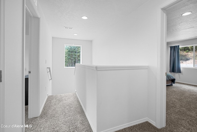 21714 S Lakeview Dr, Worley, ID 83876 - corridor with a textured ceiling, carpet, plenty of natural light, and recessed lighting