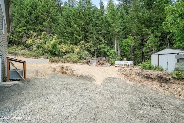 21714 S Lakeview Dr, Worley, ID 83876 - view of yard featuring an outbuilding and a view of trees