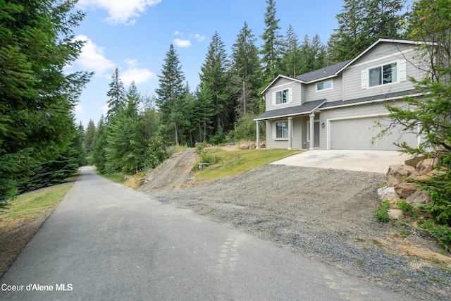 21714 S Lakeview Dr, Worley, ID 83876 - view of front of property featuring dirt driveway, an attached garage, and a shingled roof