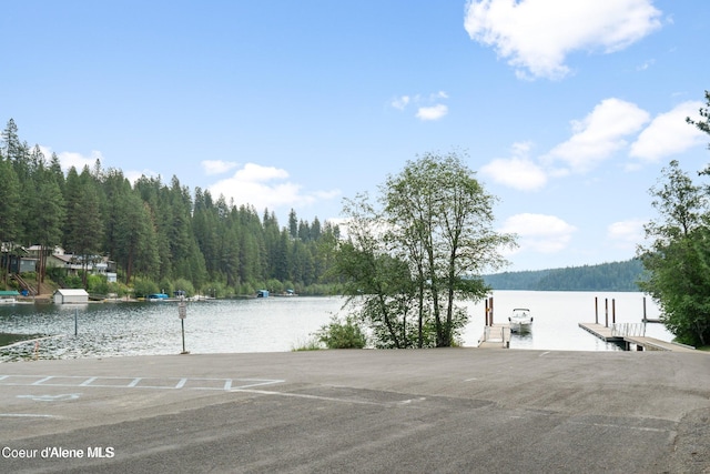 21714 S Lakeview Dr, Worley, ID 83876 - exterior space featuring a boat dock, a water view, and a wooded view