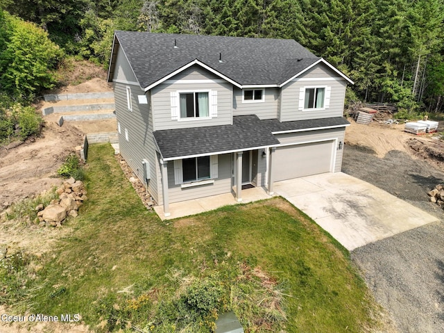 21714 S Lakeview Dr, Worley, ID 83876 - traditional-style home with a shingled roof, driveway, an attached garage, and covered porch