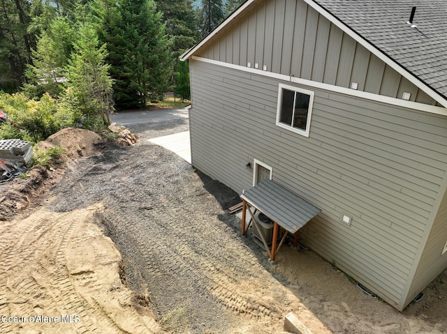 21714 S Lakeview Dr, Worley, ID 83876 - view of side of property with board and batten siding and roof with shingles
