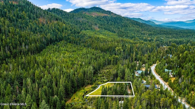 215 Gordon Dr, Priest Lake, ID 83856 - aerial overview of property's location featuring a mountain backdrop and property boundaries highlighted