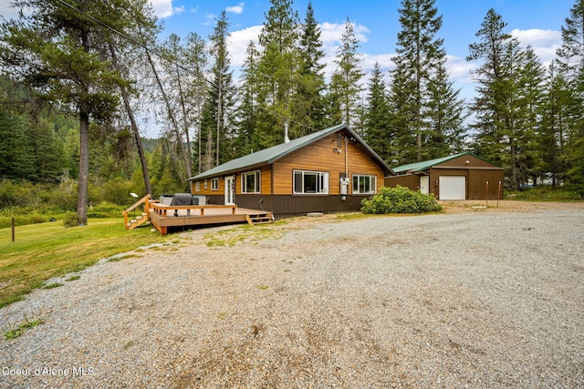 215 Gordon Dr, Priest Lake, ID 83856 - view of front of home featuring a garage, a deck, and gravel driveway