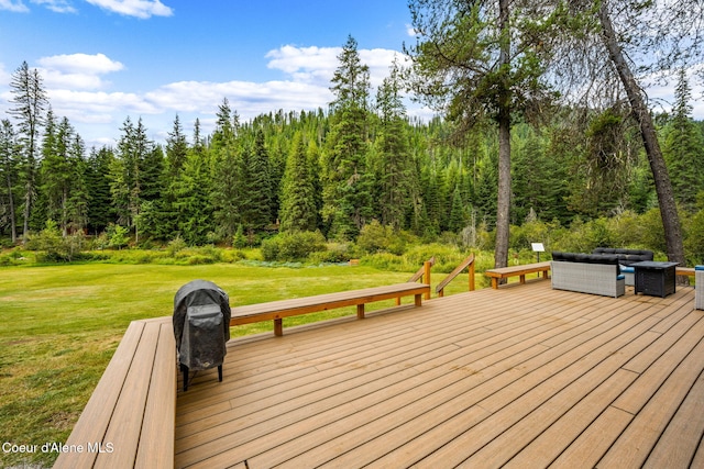 215 Gordon Dr, Priest Lake, ID 83856 - deck with a lawn, an outdoor hangout area, and a forest view